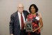 Dr. Nagib Callaos, General Chair, giving Dr. Jyothi Thalluri a plaque "In Appreciation for Delivering a Great Keynote Address at a Plenary Session."